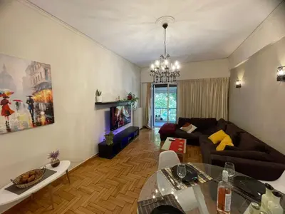 a living room with a couch and a table at Minimal Central 2BR in Athens