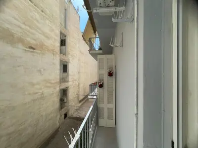 an empty hallway of a building with a balcony at Minimal Central 2BR in Athens