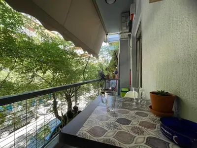 a table on a balcony with a view of a street at Minimal Central 2BR in Athens