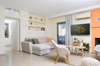 a living room with a couch and a table at Glyfada Cove Apartments-Ostria in Athens