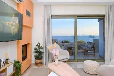 a living room with a view of the ocean at Glyfada Cove Apartments-Ostria in Athens