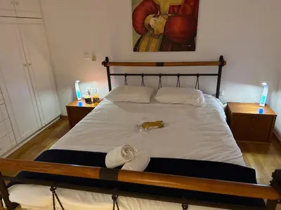 a bedroom with a bed with two towels on it at Art Blue Residence-Apartment Athens in Aghia Marina