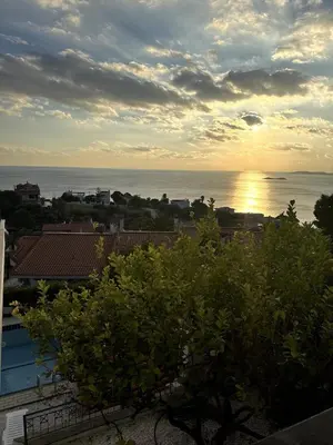 a view of the ocean at sunset from a building at Art Blue Residence-Apartment Athens in Aghia Marina