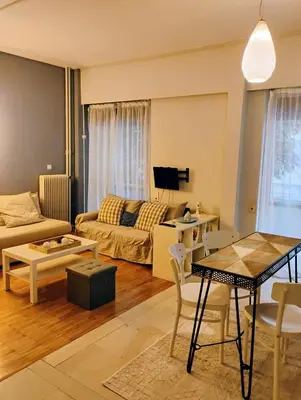 a living room with a couch and a table at Minimalistic luxury apartment in Acropolis in Athens