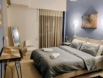 a bedroom with a bed with two towels on it at Minimalistic luxury apartment in Acropolis in Athens
