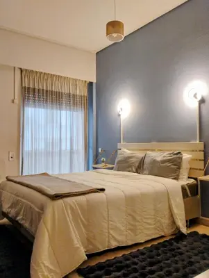 a bedroom with a large bed and a window at Minimalistic luxury apartment in Acropolis in Athens