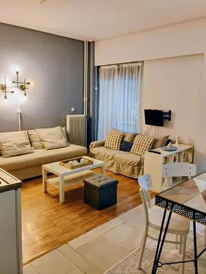 a living room with a couch and a table at Minimalistic luxury apartment in Acropolis in Athens