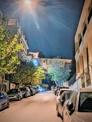 a street with cars parked on the side of the road at Minimalistic luxury apartment in Acropolis in Athens