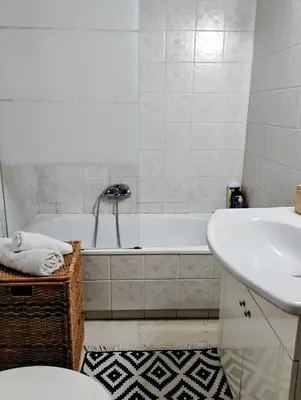a bathroom with a tub and a sink and a toilet at Minimalistic luxury apartment in Acropolis in Athens