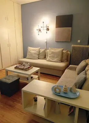 a living room with a couch and two tables at Minimalistic luxury apartment in Acropolis in Athens