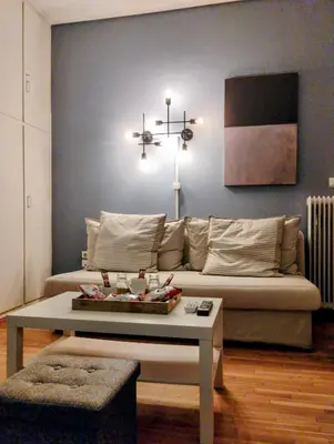 a living room with a couch and a coffee table at Minimalistic luxury apartment in Acropolis in Athens
