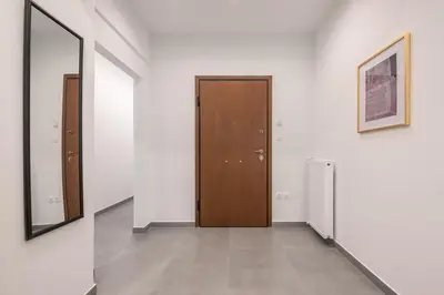 a hallway with a door and two mirrors at Minimal Harmony Apartment - Nea Smyrni by ΜΡS in Athens