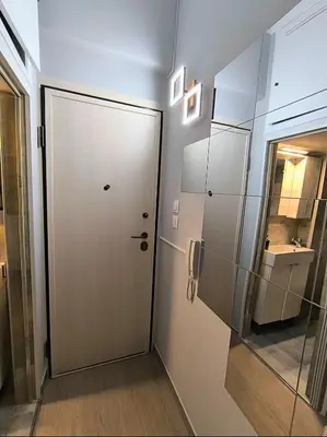 a bathroom with a white door and a sink at Stylish Urban Studio στο Γουδί in Athens
