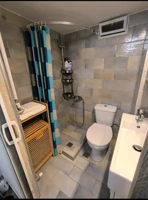 a small bathroom with a toilet and a shower at Stylish Urban Studio στο Γουδί in Athens
