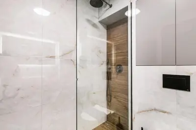 a bathroom with a shower with a glass door at Clavé - Deluxe Studio in Athens in Athens