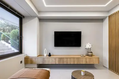 a living room with a tv and a couch at Clavé - Deluxe Studio in Athens in Athens