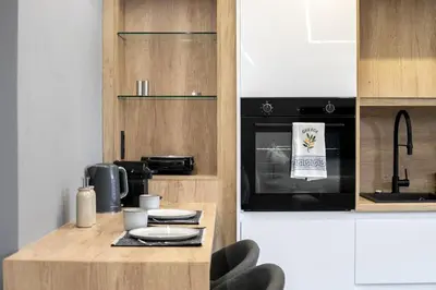 a kitchen with a counter with a stove top oven at Clavé - Deluxe Studio in Athens in Athens