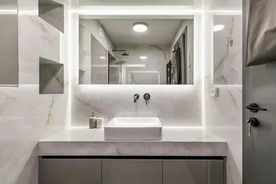 a white bathroom with a sink and a mirror at Clavé - Deluxe Studio in Athens in Athens
