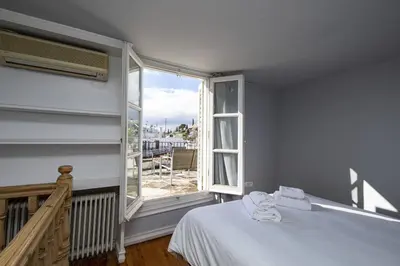a bedroom with a bed and a large window at Paul in Athens