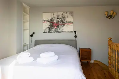 a bedroom with a white bed with towels on it at Paul in Athens
