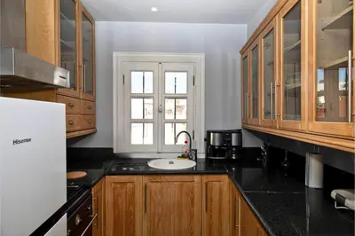 a kitchen with black counter tops and a window at Paul in Athens