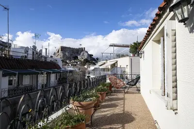 a balcony with potted plants on the side of a building at Paul in Athens