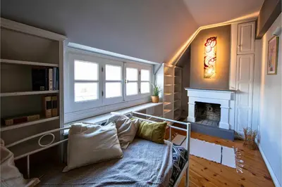 a living room with a couch and a fireplace at Paul in Athens