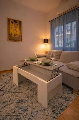 a living room with a table and a couch at Minimal Urban Apartment near Kolonaki in Athens