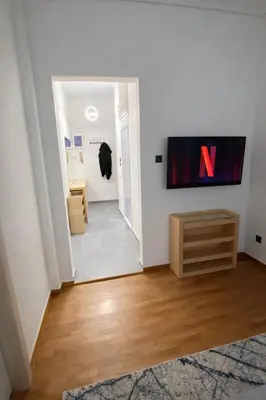 a living room with a tv on a wall at Minimal Urban Apartment near Kolonaki in Athens