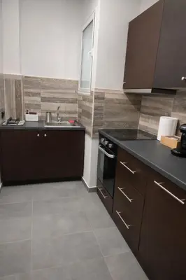 a kitchen with a sink and a counter top at Minimal Urban Apartment near Kolonaki in Athens