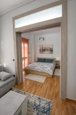 a bedroom with a bed and a couch at Minimal Urban Apartment near Kolonaki in Athens