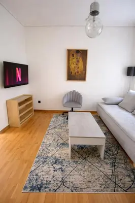 a living room with a couch and a coffee table at Minimal Urban Apartment near Kolonaki in Athens