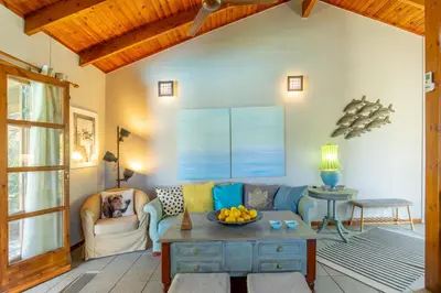 a living room with a couch and a table at Iliachtida House in Sounio