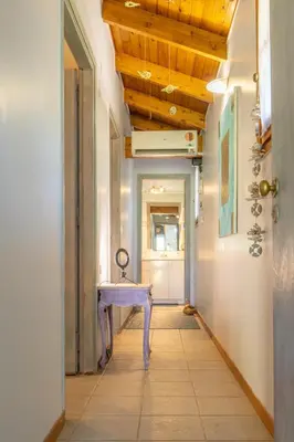 a hallway with a purple table in a room at Iliachtida House in Sounio
