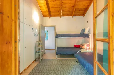 a bedroom with two bunk beds and a doorway at Iliachtida House in Sounio