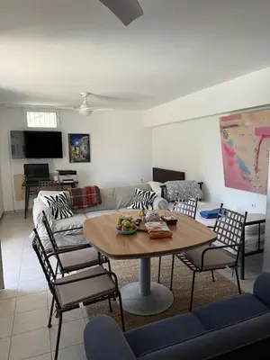 a living room with a table and chairs and a couch at ART BLUE RESIDENCE Pool in Aghia Marina