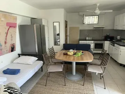 a living room with a table and a kitchen at ART BLUE RESIDENCE Pool in Aghia Marina