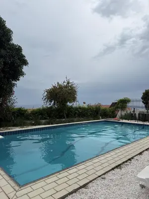 a large swimming pool with blue water at ART BLUE RESIDENCE Pool in Aghia Marina