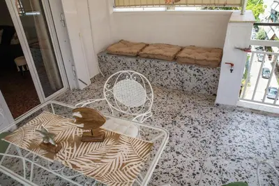 a room with a chair and a table and a couch at Bohemian Sunny apt Athens Center in Athens