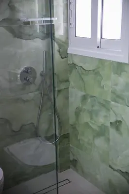 a shower with a glass door in a bathroom at Bohemian Sunny apt Athens Center in Athens