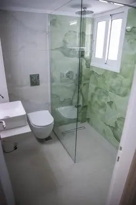 a bathroom with a shower and a toilet and a sink at Bohemian Sunny apt Athens Center in Athens
