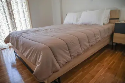 a bed with a brown blanket on top of it at Bohemian Sunny apt Athens Center in Athens