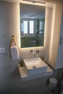 a bathroom with a white sink and a mirror at Bohemian Sunny apt Athens Center in Athens