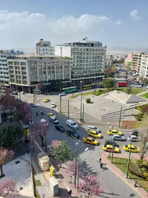 a city with cars parked in a parking lot at Gousa Urban Stay 2 Min Walk to Metro in Athens
