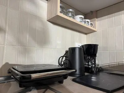 a kitchen with a coffee maker on a counter at Aiolos cozy GLYFADA near the centre in Athens