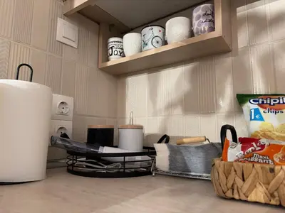 a kitchen with a counter top with dishes on a shelf at Aiolos cozy GLYFADA near the centre in Athens