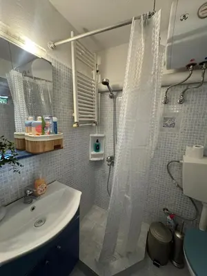 a bathroom with a sink and a shower with a shower curtain at Aiolos cozy GLYFADA near the centre in Athens
