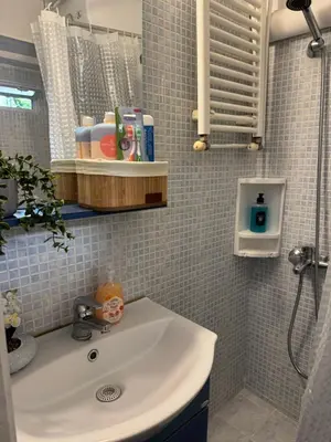 a bathroom with a sink and a shower at Aiolos cozy GLYFADA near the centre in Athens