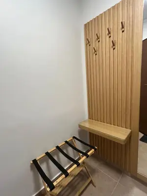 a room with a bed and a wooden cabinet at Κομψό Διαμέρισμα στο Πασαλιμάνι in Piraeus