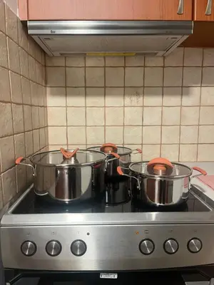 two pots on top of a stove in a kitchen at Κομψό Διαμέρισμα στο Πασαλιμάνι in Piraeus